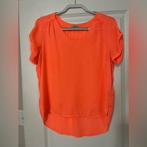Salmon colored top with button on sleeve. Cute for work or evening out.